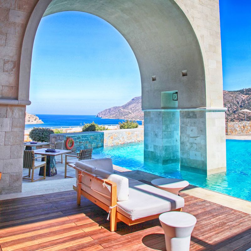 Grecian resort pool by the ocean